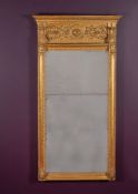 A carved giltwood and composition wall mirror