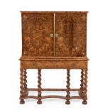 A Charles II walnut and olivewood oyster veneered cabinet on stand