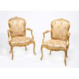 A pair of George III carved giltwood armchairs