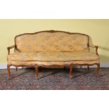 A Louis XV carved beech and upholstered sofa