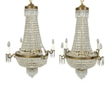 A pair of cut glass and gilt metal mounted four branch chandeliers in Regency taste