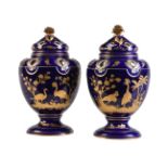 A pair of English porcelain blue-ground and gilt pot pourri urns and covers in the Sevres-style (pot