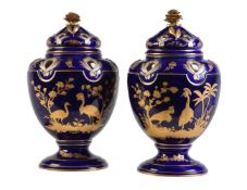 A pair of English porcelain blue-ground and gilt pot pourri urns and covers in the Sevres-style (pot