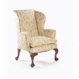 A George II walnut and leather upholstered wing armchair