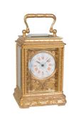 A fine French engraved gilt brass miniature carriage timepiece