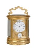 A fine engraved gilt brass oval carriage clock with push-button repeat and alarm