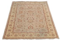 A modern Afghan carpet of Zeigler design, 20th century, a beige field with a design of flowers and