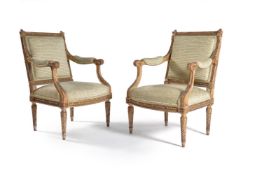 A pair of Louis XVI style carved giltwood fauteuils, late 19thcentury, the rectangular padded backs,