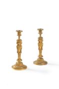 A pair of fine gilt bronze candlesticks after designs by Jean-Démosthène Dugourc, early 19th