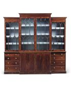 A George III mahogany breakfront library bookcase, late 18th century, the moulded and inlaid