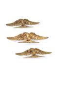 A set of three gilt bronze surmounts, probably overdoors, late 19th century, cast as spreadeagles,