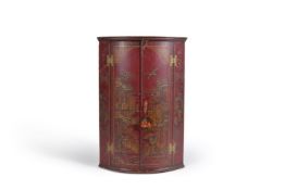 A red and gilt japanned bow-fronted hanging corner cabinet, 18th century, with later decoration, the