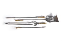 A set of three early Victorian steel and brass mounted fire tools in Rococo Revival taste, mid