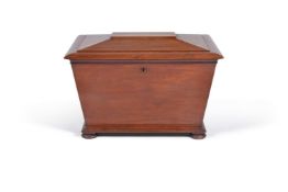 A William IV mahogany wine cooler, of sarcophagus form, the chamfered hinged top now revealing a