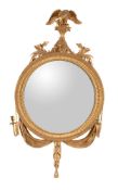 A Victorian giltwood and composition convex wall mirror in Regency style, circa 1865, with eagle