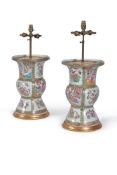 A pair of Cantonese Gu vases, 19th century, each painted with alternating panels of figures
