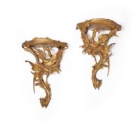 A pair of carved and giltwood wall brackets in Rococo style, 19th century, each with demi lune top