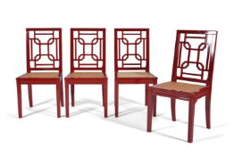 A set of four red lacquered side chairs, 20th century, with stylised Chinese style backs above