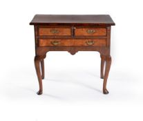 A George I walnut and mahogany banded side table, circa 1720, with two short and one long drawer and