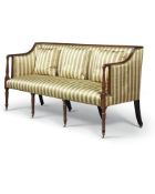 A late George III mahogany and striped silk upholstered sofa, circa 1810, the raised back and arms