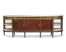 A French ormolu-mounted mahogany sideboard in the Louis XVI style, circa 1910, the shaped marble top