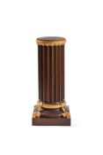 A carved oak and parcel gilt pedestal, early 20th century, of fluted columnar form with foliate