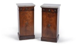 A pair of mahogany pedestal cupboards, circa 1815 and later, each with later grey marble top, the