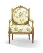 A French carved giltwood armchair, late 19th century, in the Louis XVI style, the arched back