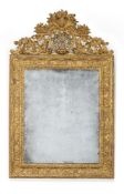 A Regence giltwood mirror, circa 1720, carved in relief with foliage, the cresting with a central