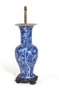 A large Chinese blue and white vase, late 19th century, painted with flowering prunus on a cracked-