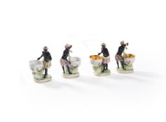 Two pairs of Berlin porcelain table salt figures of blackamoors, late 19th century, with oval