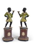 A pair of painted composition blackamoor torchere stands, 20th century, modelled opposing with