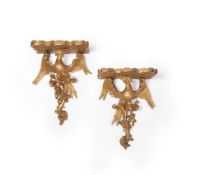 A pair of carved and giltwood wall brackets in Rococo style, 20th century, with serpentine tops