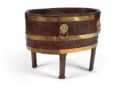 A George III mahogany and brass bound wine cooler, late 18th century, of oval coopered form with