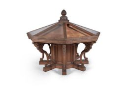 A Victorian oak octagonal display table, late 19th century, the tope centred by a pineapple finial