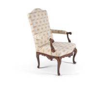 An Italian walnut and upholstered armchair, 18th century, the serpentine back, padded arms and