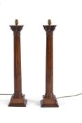 A pair of carved and stained wood columnar table lamps, modern, the Corinthian order capitals