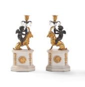 A pair of gilt and patinated bronze and white marble mounted figural candle holders in the manner of