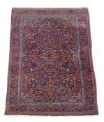 A Kashan rug, the royal-blue field with floral sprays around concentric red and ivory floral