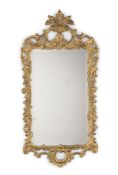 A George II carved giltwood wall mirror, mid-18th century, the later bevelled plate within a pierced