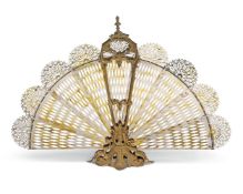 A gilt metal fan fire screen in Rococo style