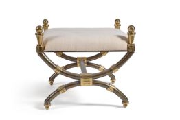 A gilt and patinated metal footstool, mid-20th century, of X-frame type, 58cm high, 66cm square