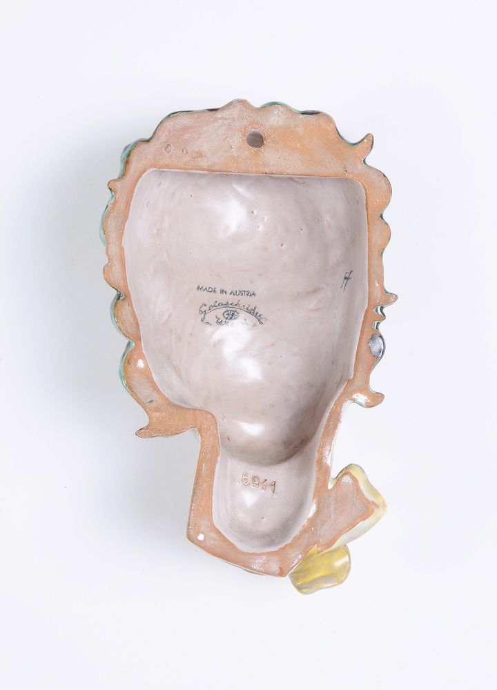 Goldscheider, a painted terracotta wall mask of a lady with a bow - Image 2 of 2
