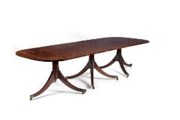 A mahogany triple pillar dining table in Regency style,