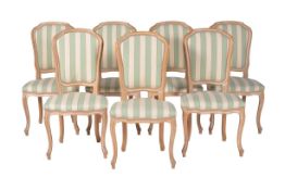 A set of seven modern limed beechwood dining chairs in Louis XV style