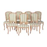 A set of seven modern limed beechwood dining chairs in Louis XV style