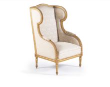 A Louis XVI style giltwood wing armchair