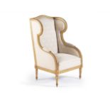A Louis XVI style giltwood wing armchair