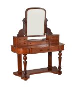 A Victorian mahogany dressing table with arched toilet mirror and five small drawers