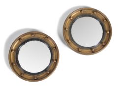 A pair of Regency style giltwood convex wall mirrors